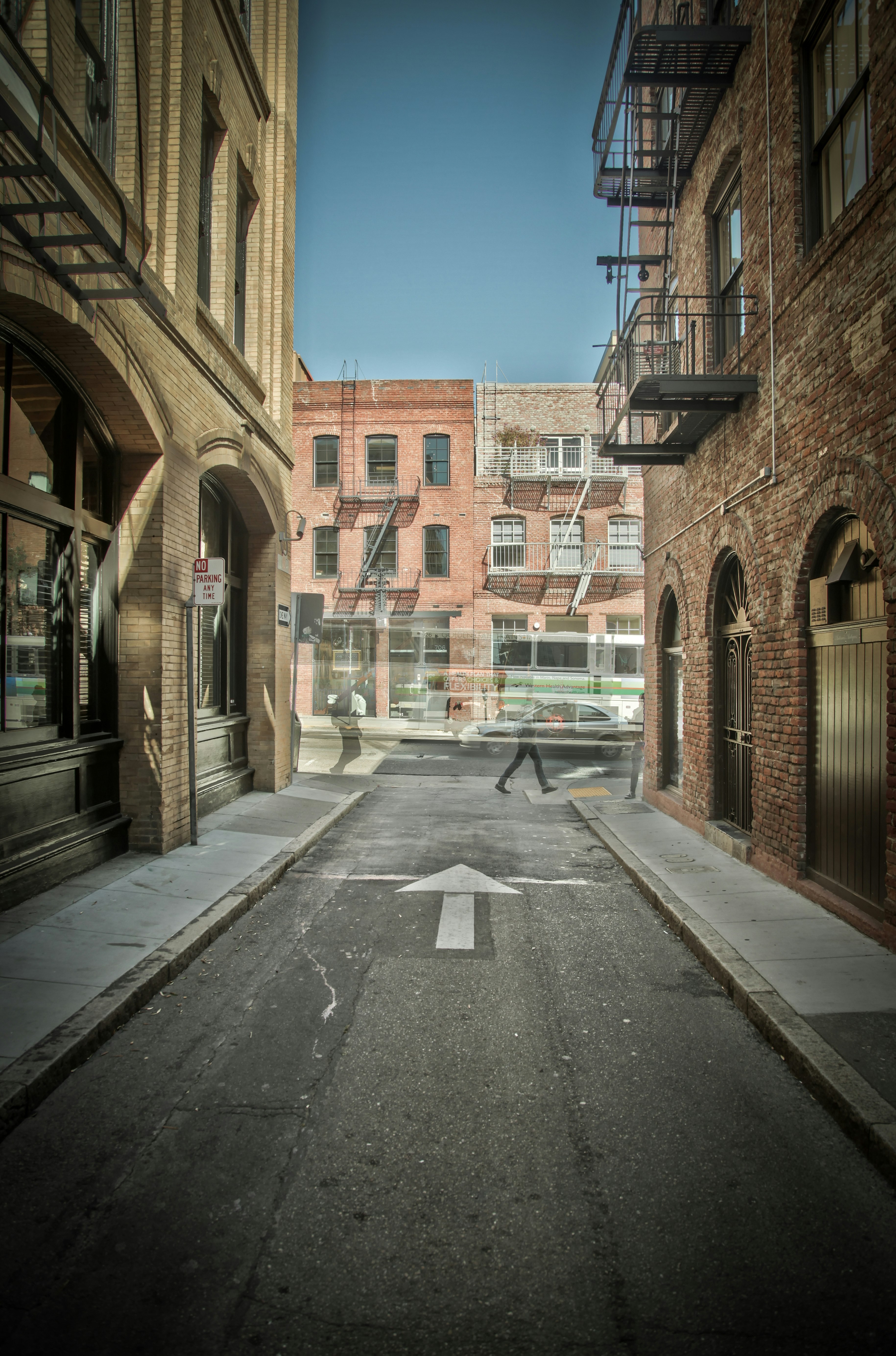 gray concrete road and brown buildings during daytime